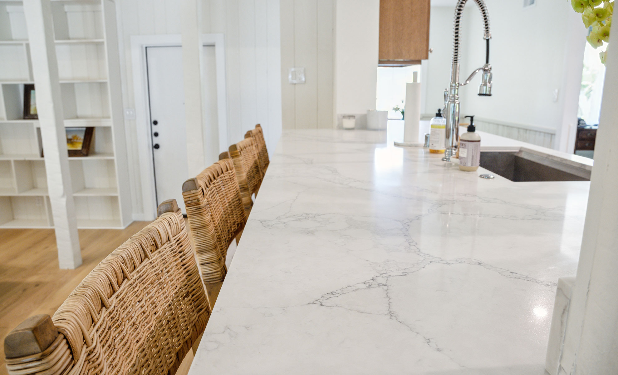A clean, polished quartz countertop is pictured in a kitchen.